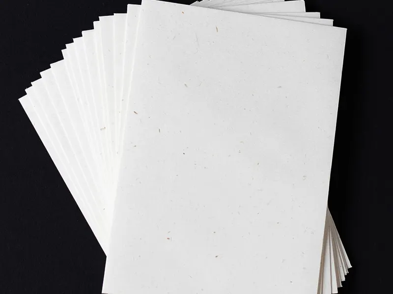 Fanned stack of white art paper sheets